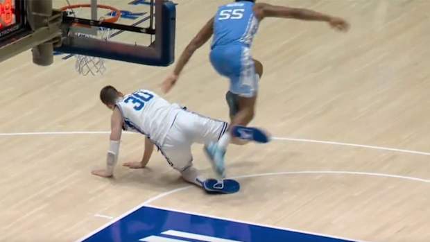 Duke center Kyle Filipowski appears to trip UNC forward Harrison Ingram.